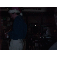 A close up of Old Saint Nick buying a drink.