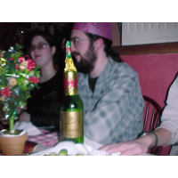 The alchohol starts to affect people - the result - the remains of a cracker on top of a wine bottle.