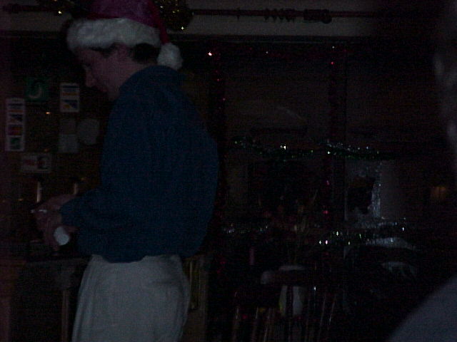 A close up of Old Saint Nick buying a drink.