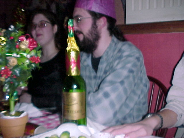 The alchohol starts to affect people - the result - the remains of a cracker on top of a wine bottle.